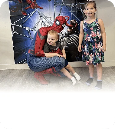 An image of kids attending a superhero-themed special event